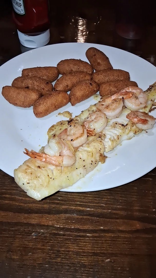A family-style meal with burgers, fries, and seafood.